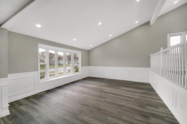 unfurnished room featuring dark hardwood / wood-style flooring and vaulted ceiling with beams