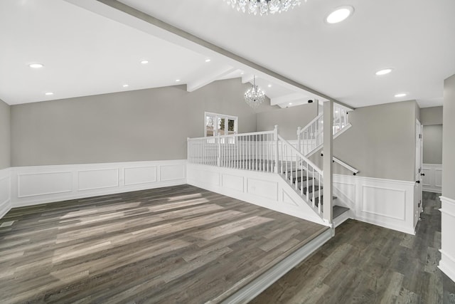 staircase with a chandelier, lofted ceiling with beams, and wood-type flooring