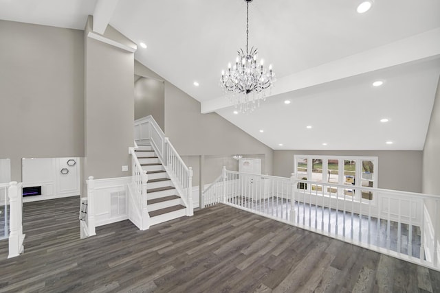 unfurnished living room featuring beam ceiling, a chandelier, high vaulted ceiling, and dark wood-type flooring