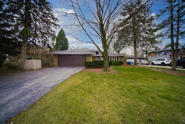 view of front of house with a garage and a front yard