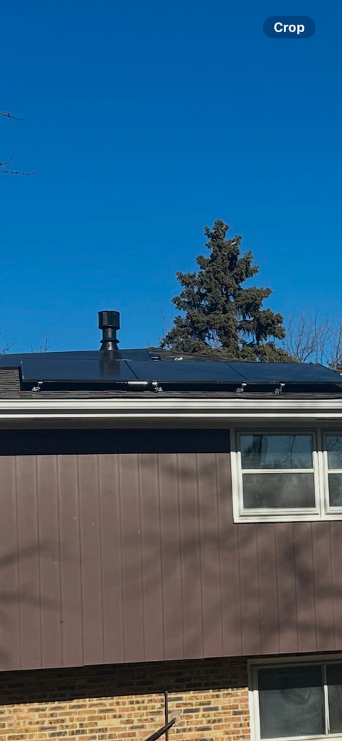 view of side of home featuring solar panels