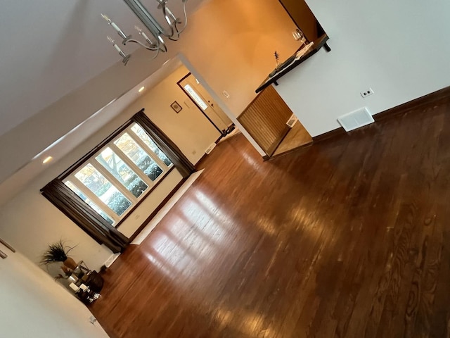 unfurnished living room with dark wood-type flooring