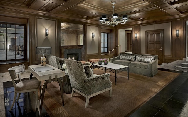 cinema room with a notable chandelier, wood ceiling, crown molding, and wooden walls