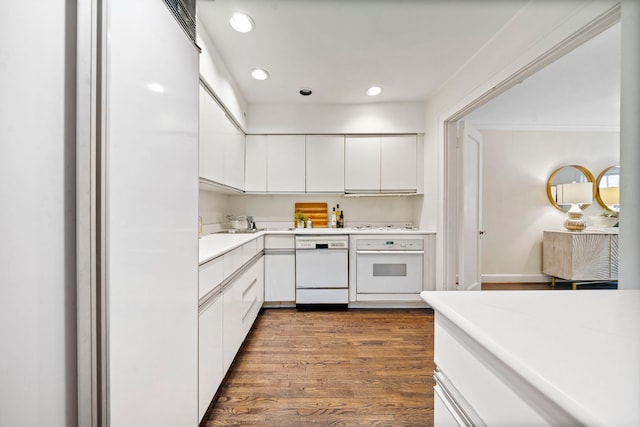 kitchen featuring white appliances, dark wood-style floors, light countertops, white cabinetry, and recessed lighting