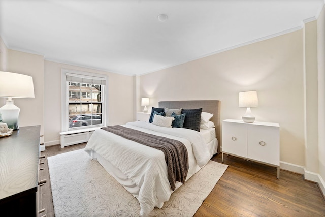 bedroom featuring baseboards and wood finished floors