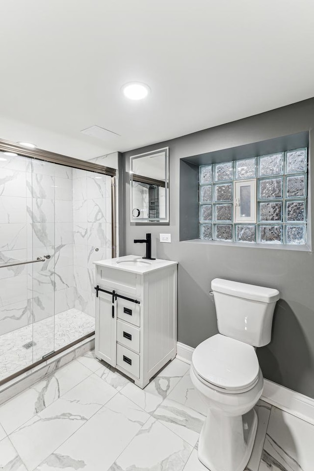 bathroom with a marble finish shower, baseboards, toilet, marble finish floor, and vanity