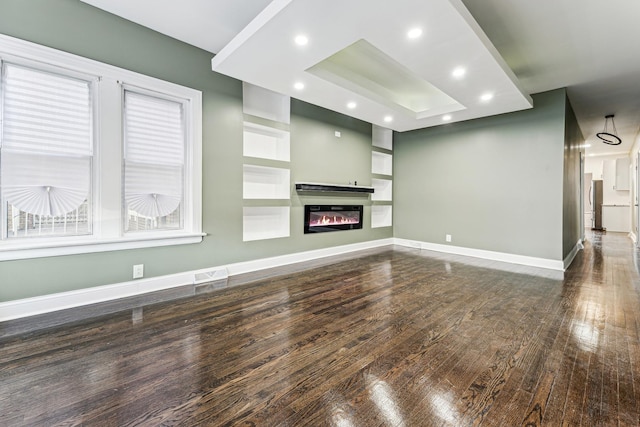 unfurnished living room featuring dark hardwood / wood-style flooring