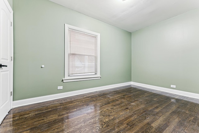 empty room with dark wood-type flooring