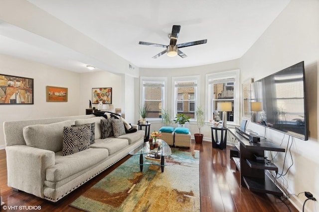 living room featuring ceiling fan and dark hardwood / wood-style flooring