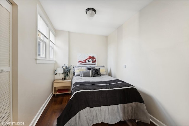 bedroom with dark hardwood / wood-style flooring