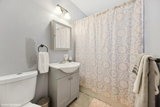 bathroom with tile patterned flooring, vanity, curtained shower, and toilet