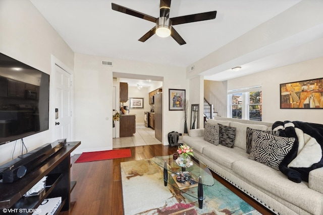 living room featuring light wood-type flooring and ceiling fan