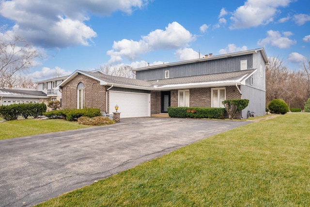 view of front of property featuring a garage and a front lawn