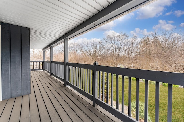 wooden terrace with a lawn