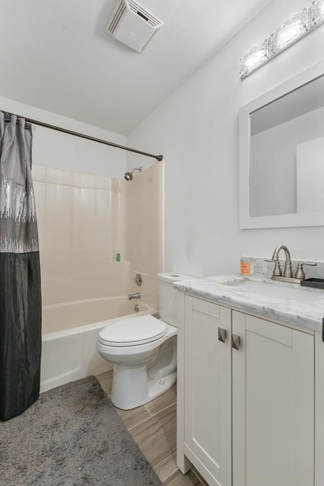 full bathroom with shower / bathtub combination with curtain, toilet, vanity, and hardwood / wood-style flooring