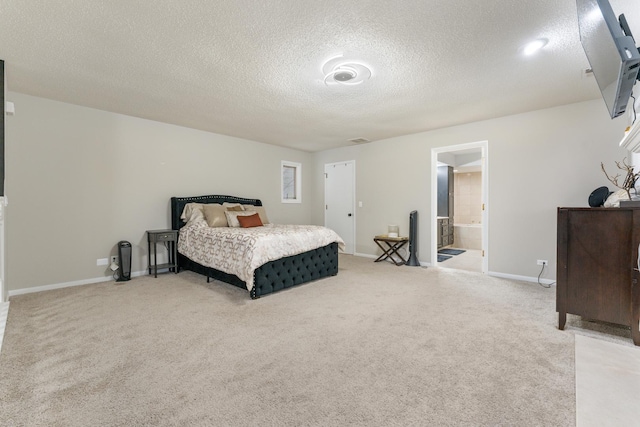 carpeted bedroom featuring ensuite bathroom and a textured ceiling