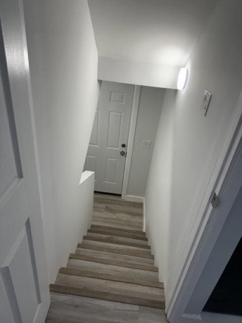 stairs featuring hardwood / wood-style flooring