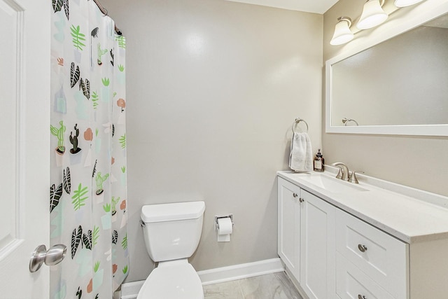 bathroom featuring toilet, vanity, and walk in shower