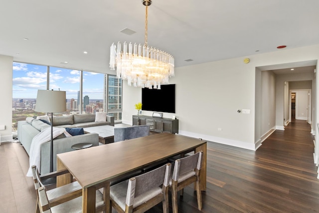 dining space with dark hardwood / wood-style floors and an inviting chandelier