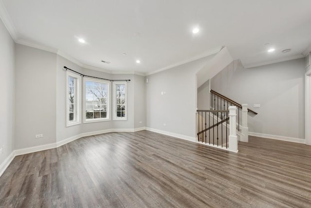 empty room featuring hardwood / wood-style floors and crown molding