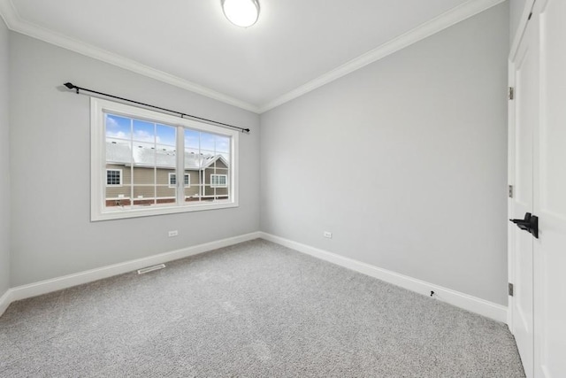 carpeted spare room featuring crown molding