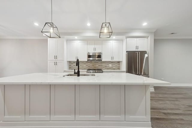 kitchen with appliances with stainless steel finishes, light stone countertops, a spacious island, and pendant lighting