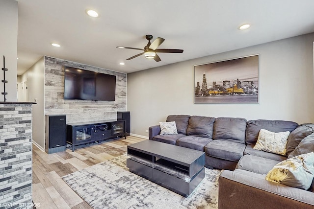 living room featuring ceiling fan and light hardwood / wood-style floors