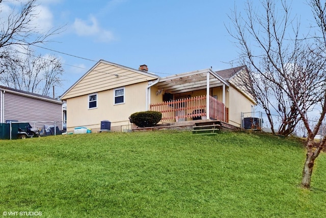 rear view of property with a yard