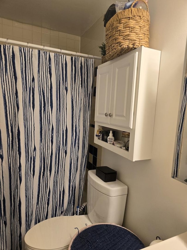 bathroom featuring toilet and walk in shower