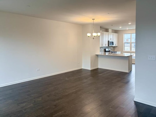 interior space featuring dark wood-type flooring and an inviting chandelier