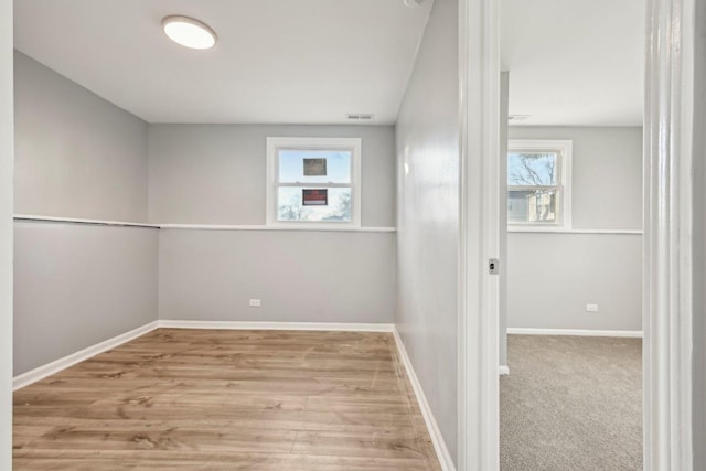 unfurnished room featuring light wood-type flooring and a wealth of natural light