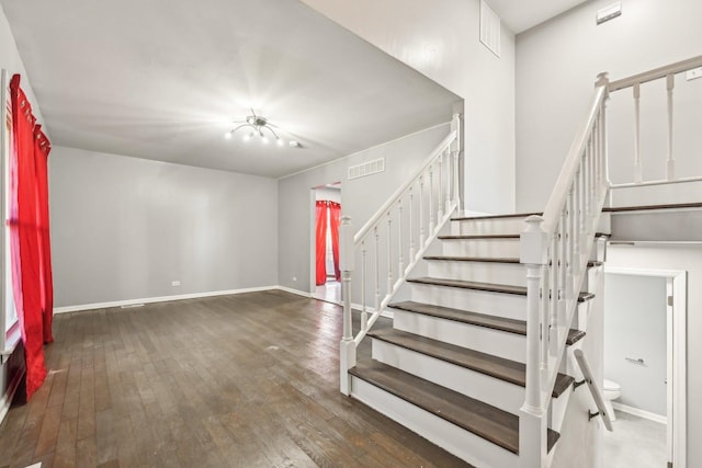 stairs featuring hardwood / wood-style floors