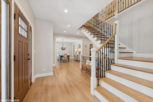 entryway featuring hardwood / wood-style floors and an inviting chandelier