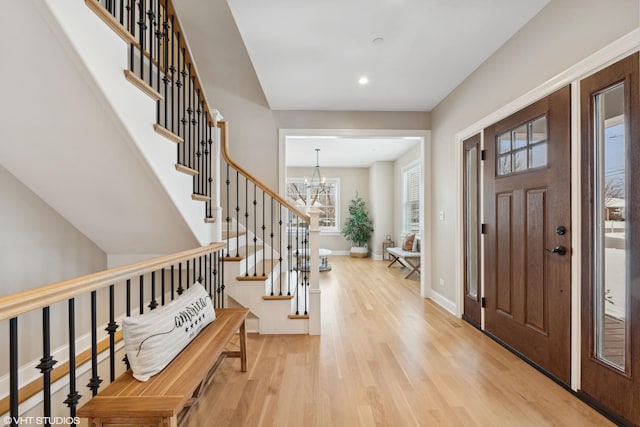 entryway featuring light hardwood / wood-style floors and a notable chandelier