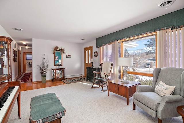 living room featuring hardwood / wood-style flooring and a baseboard heating unit