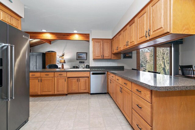 kitchen with crown molding, a breakfast bar, kitchen peninsula, and appliances with stainless steel finishes