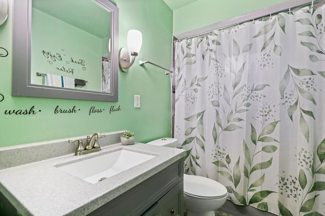 bathroom with vanity, toilet, and walk in shower