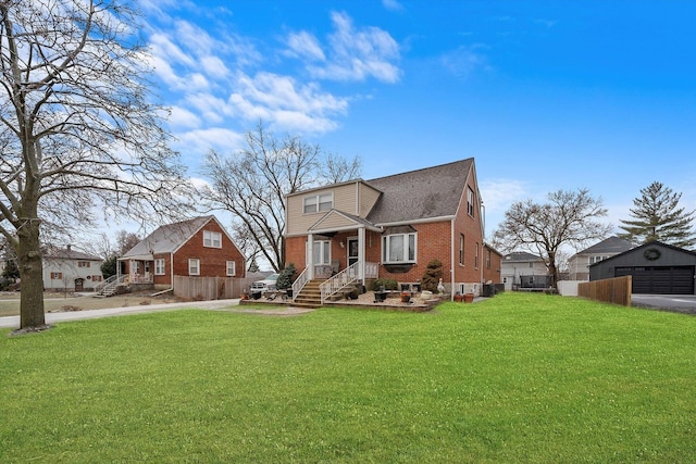 view of front of house with an outbuilding, a front yard, and a garage