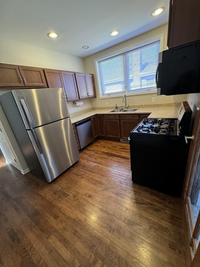 kitchen featuring stainless steel appliances, dark hardwood / wood-style floors, and sink