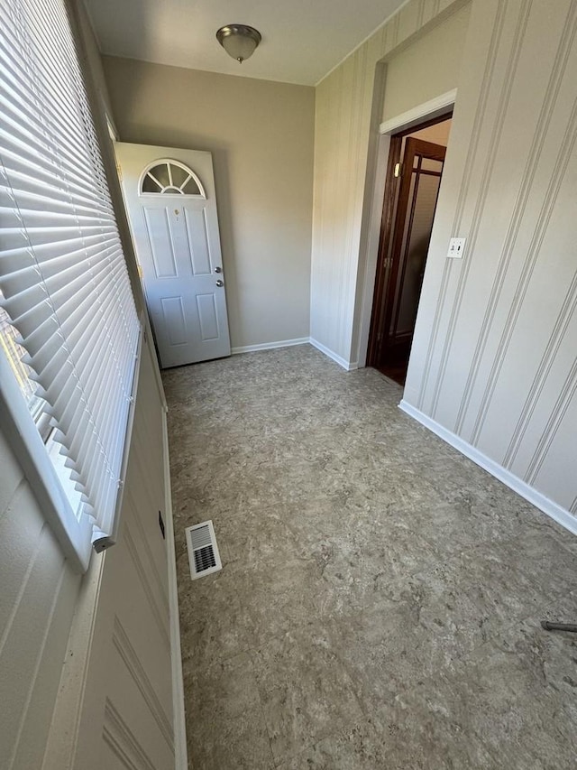 property entrance with visible vents and a balcony