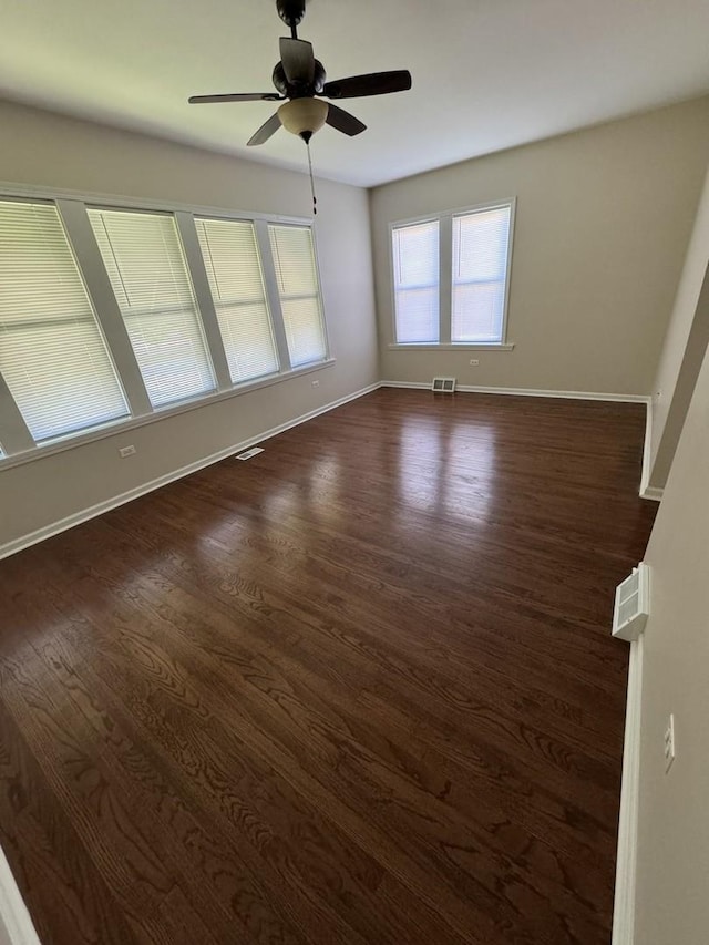 empty room featuring ceiling fan and dark hardwood / wood-style floors