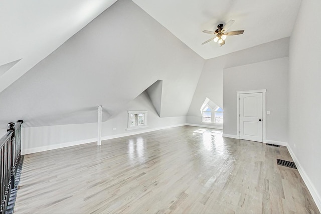 additional living space with ceiling fan, light hardwood / wood-style floors, and vaulted ceiling