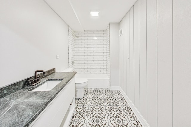 bathroom featuring tile patterned flooring, vanity, and toilet