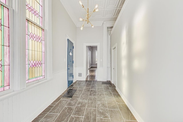 hallway with a high ceiling and an inviting chandelier