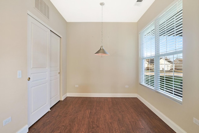 empty room with dark wood-type flooring