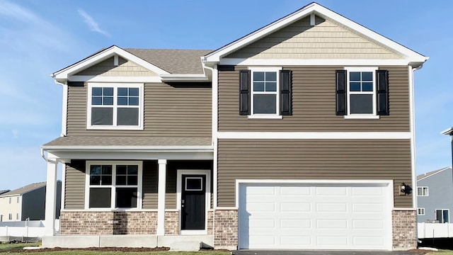 craftsman inspired home featuring covered porch and a garage