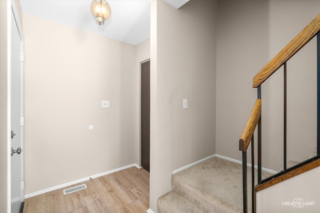 stairway with hardwood / wood-style flooring