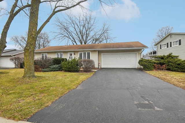 single story home with a front yard and a garage