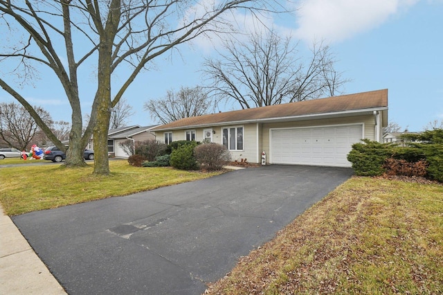 single story home with a garage and a front lawn