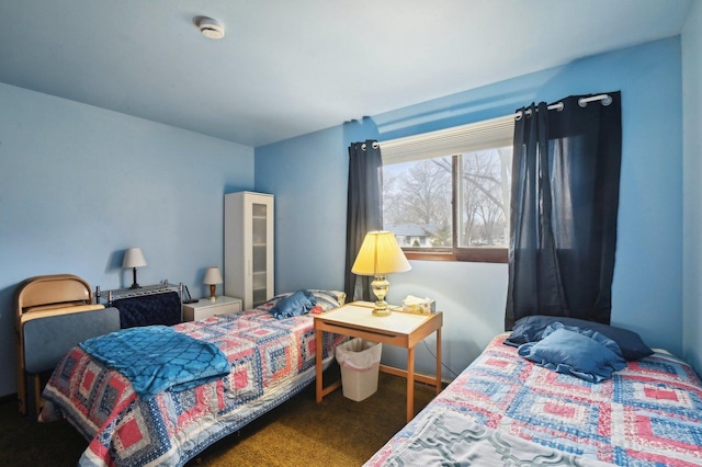 bedroom with dark colored carpet